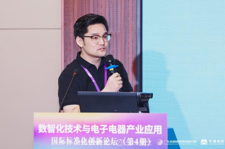 A person standing at a podium with a microphone

Description automatically generated